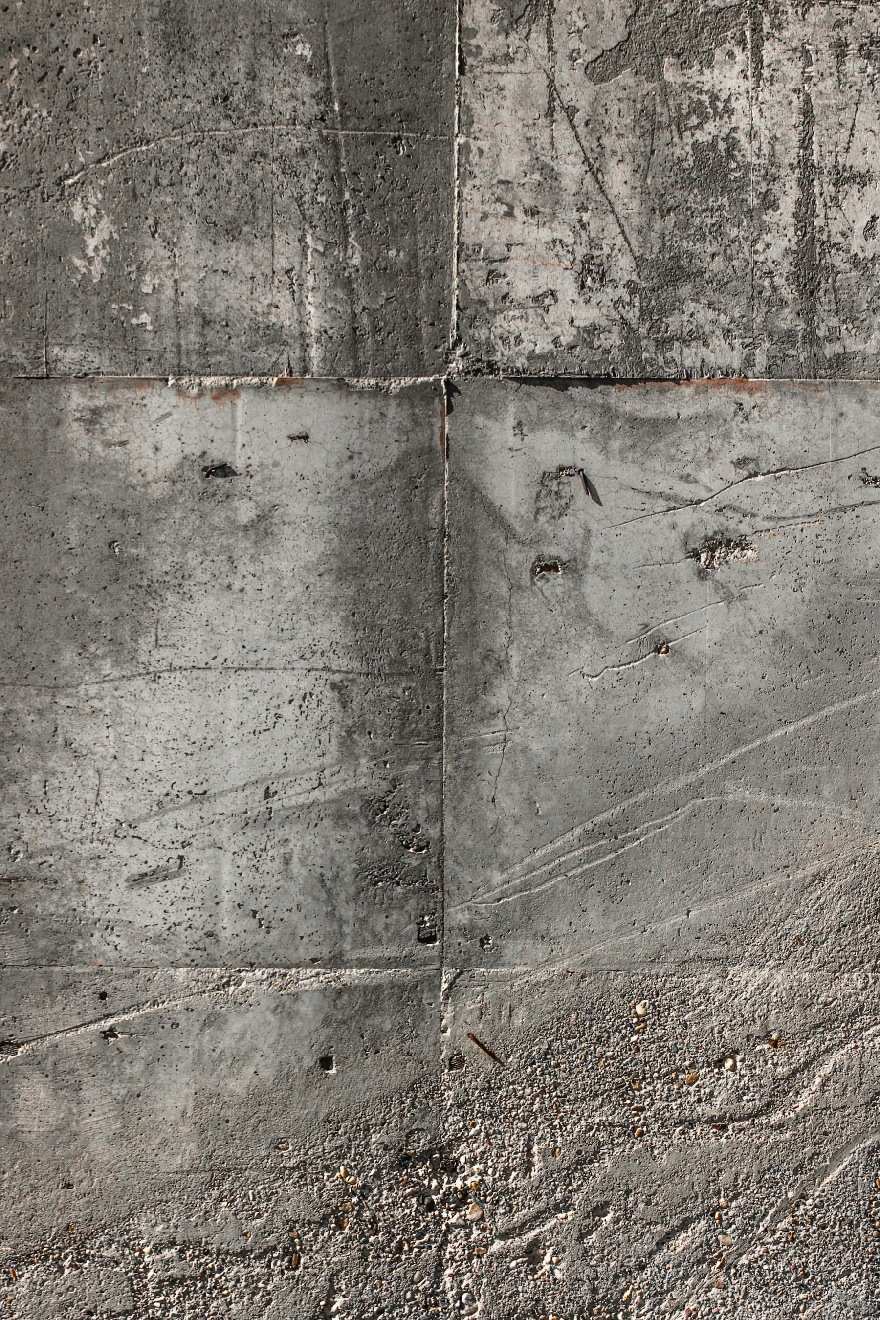 Freshly poured concrete surface with visible aggregate and joint