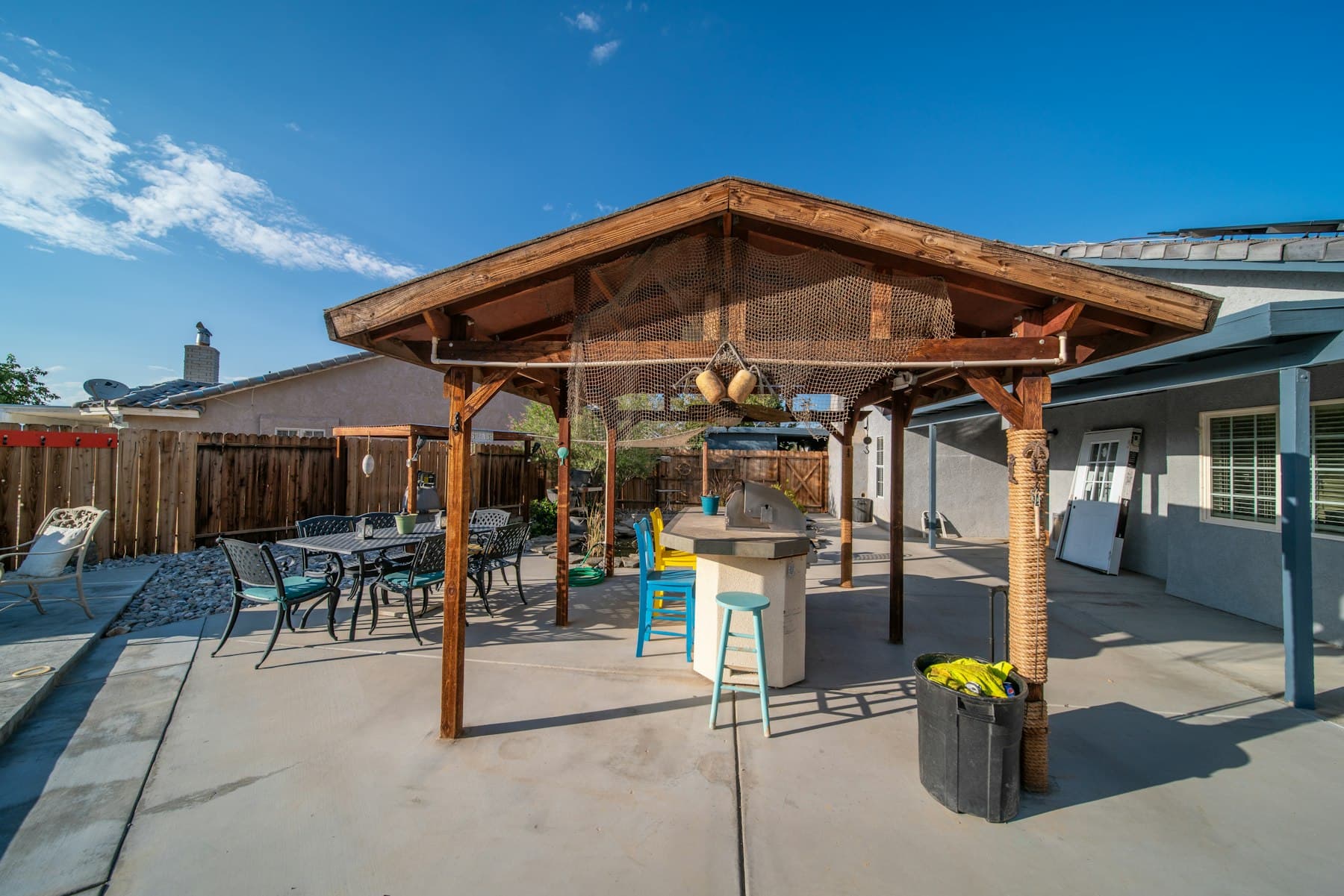 Natural cedar covered patio with dining set in a Central Valley residential backyard