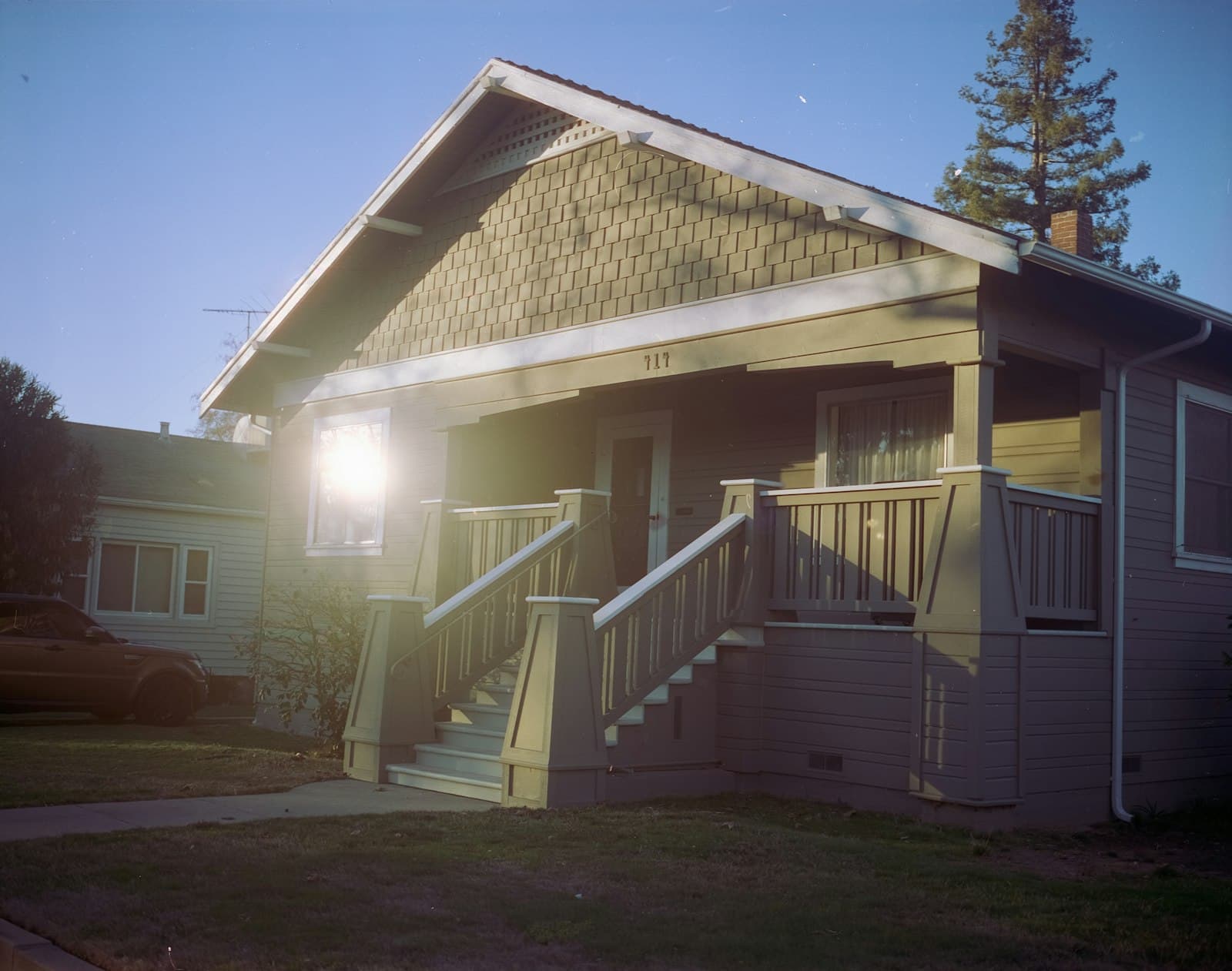 Central Valley Craftsman bungalow in warm afternoon sun with covered porch